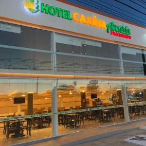 a hotel cantina with tables and chairs in a building at HOTEL CAJUINA AVENIDA in Teresina