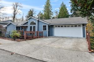 a blue house with a driveway at Tanner Basin Retreat in West Linn