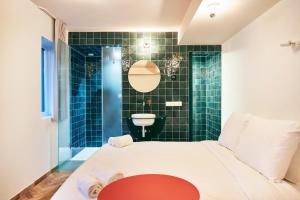 a room with a bed and a bathroom with a sink at Hotel Not Hotel Rotterdam in Rotterdam +29 photos