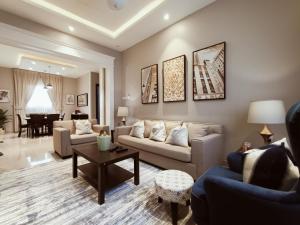 a living room with two couches and a table at F residence, Beauty & Luxury in Riyadh