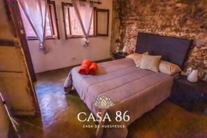 Łóżko lub łóżka w pokoju w obiekcie Casa 86