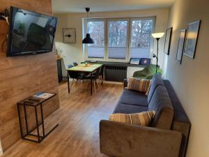 a living room with a couch and a table at Brzeźno plaża in Gdańsk