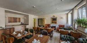 a restaurant with tables and chairs in a room at Bayrischer Hof in Krefeld