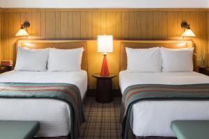 a hotel room with two beds and a lamp at The Virginian Lodge, an Outbound Hotel in Jackson +111 photos