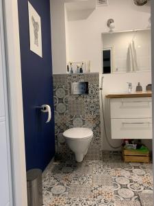 a bathroom with a toilet and a sink at Brzeźno plaża in Gdańsk +16 photos
