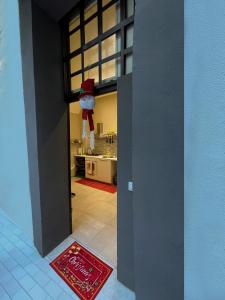 a door to a kitchen with a stuffed animal hanging from the ceiling at PortaMedina House in Naples