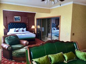a hotel room with a bed and a couch at Eureka Inn, Trademark Collection by Wyndham in Eureka