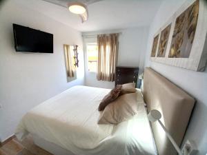 Postel nebo postele na pokoji v ubytování Apartamentos Medano - Lagos de Miramar Deluxe