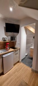 a kitchen with a sink and a counter top at La Chouette in Gérardmer
