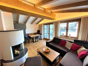 a living room with a couch and a fireplace at Sonnenschein Appartement Rebecca in Kirchberg in Tirol