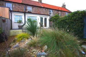 a house with a garden in front of it at Sea Hollies in Aberdour