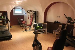 a gym with exercise equipment in a room at GH Palazzo Suite & SPA in Livorno
