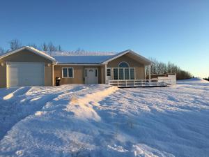 a house with a lot of snow in front of it at Iceland Inn Lodge, entire place with hot tub. in Selfoss