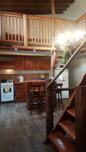 a kitchen with wooden cabinets and a table and chairs at Cabañas La Polaca 2 in Santa Clara del Mar