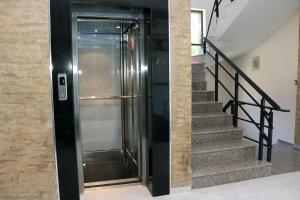 a elevator in a building with a set of stairs at Polina Beach in Sozopol