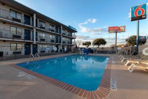 a large swimming pool in front of a hotel at Motel 6-San Antonio, TX - West SeaWorld in San Antonio