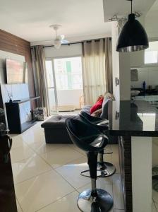 a living room with a couch and a bar stool at #Apartamento completo próximo CPO , centrinho , FUNCRAF, USP ,medicina , mondelli, vitória régia ,bar da rosa , FACOP in Bauru