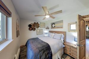een slaapkamer met een bed en een plafondventilator bij Hi Country Haus 14-5 in Winter Park