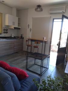 sala de estar con sofá, mesa y cocina en OLASCOAGA DOS monoambiente en Mendoza