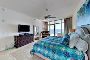 a bedroom with a bed and a flat screen tv at Turquoise Place #2205C in Orange Beach
