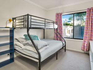 a bedroom with a bunk bed and a window at Starfish Sands in Cowes +13 photos