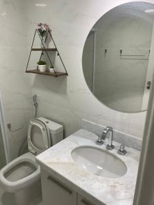 a bathroom with a sink and a toilet and a mirror at Suíte rio stay rio centro, jeunesse arena, rock in rio, globo in Rio de Janeiro