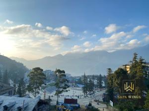 a view of a city with mountains in the background at Sapa Wings Hotel in Sapa