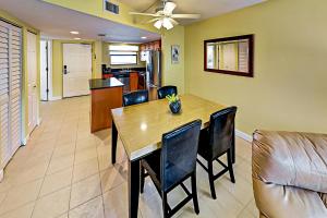 a dining room and kitchen with a table and chairs at Vistas On The Gulf Unit 408 in St. Pete Beach