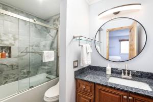 a bathroom with a shower and a sink and a mirror at Woodbridge 21C in Snowmass Village +41 photos