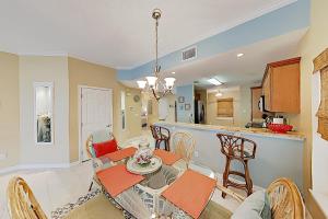 a dining room and kitchen with a table and chairs at Villas Ocean Gate II Condo Unit 105 in St. Augustine