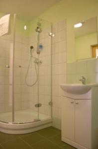 a bathroom with a shower and a sink at Liedags Guesthouse in Jūrkalne