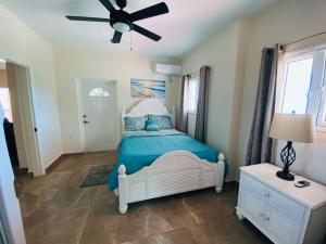 a bedroom with a bed and a ceiling fan at Sea-Renity in Philipsburg +70 photos