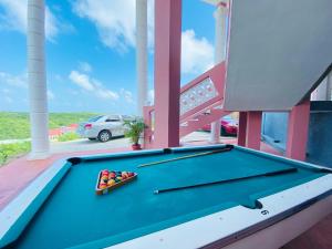 a pool table on the balcony of a house at Sea-Renity in Philipsburg