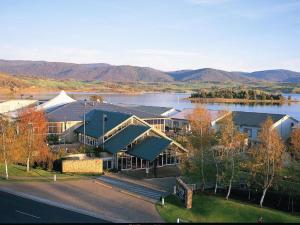 an aerial view of a large building with a lake at Horizons 414 - Deluxe Lake Front Studio l Pool l Tennis l WiFi in Jindabyne