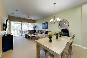 a living room with a table and a couch at Greenlink Resort 421 in Naples