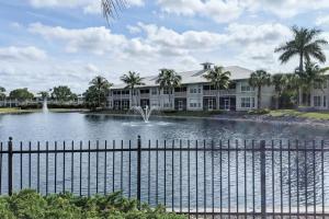 a building with a fountain in the middle of a lake at Greenlink Resort 421 in Naples