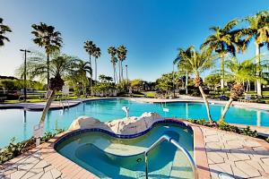 a swimming pool with a slide in a resort at Grand View #103 in Fort Myers