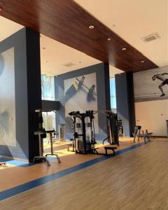a gym with exercise equipment in a large room at Camino al mar "Departamento en playa" in Mazatlán