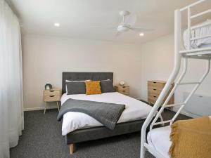 a bedroom with a bunk bed and a ladder at Lansell Retreat in Cowes