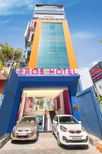 dos coches estacionados frente a un hotel en EROS HOTEL 2 - Love Hotel en Ho Chi Minh