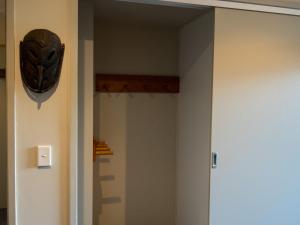 a hallway with a mask hanging on the wall at Les Perrieres Studio in Crackenback