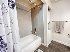 a bathroom with a white tub and a toilet at HOMEY PARIS - NEW / Free garage parking / Downtown Salt Lake City in Salt Lake City +27 photos
