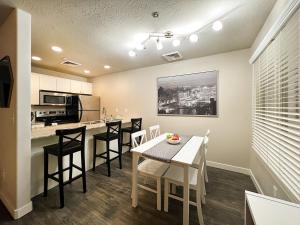 a kitchen and dining room with a table and chairs at HOMEY PARIS - NEW / Free garage parking / Downtown Salt Lake City in Salt Lake City