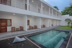 a swimming pool in the courtyard of a house at Maisaba Canggu Hotel & Coworking Space in Canggu