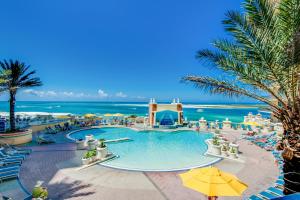 a pool at a resort with the ocean in the background at Emerald Grande in Destin