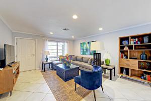 a living room with a couch and a tv at Breezy Ocean Escape in Lake Worth