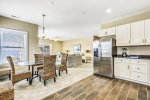 a kitchen and dining room with a table and chairs at Bella Sun 201a in Ocean City