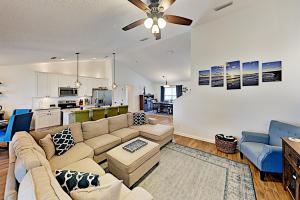 a living room with a couch and a kitchen at Trade Wind Cabana in St. Augustine