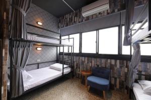 Ένα ή περισσότερα κρεβάτια σε δωμάτιο στο Topbunk Hostel