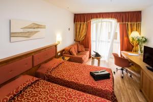 Postel nebo postele na pokoji v ubytování Sartori's Hotel